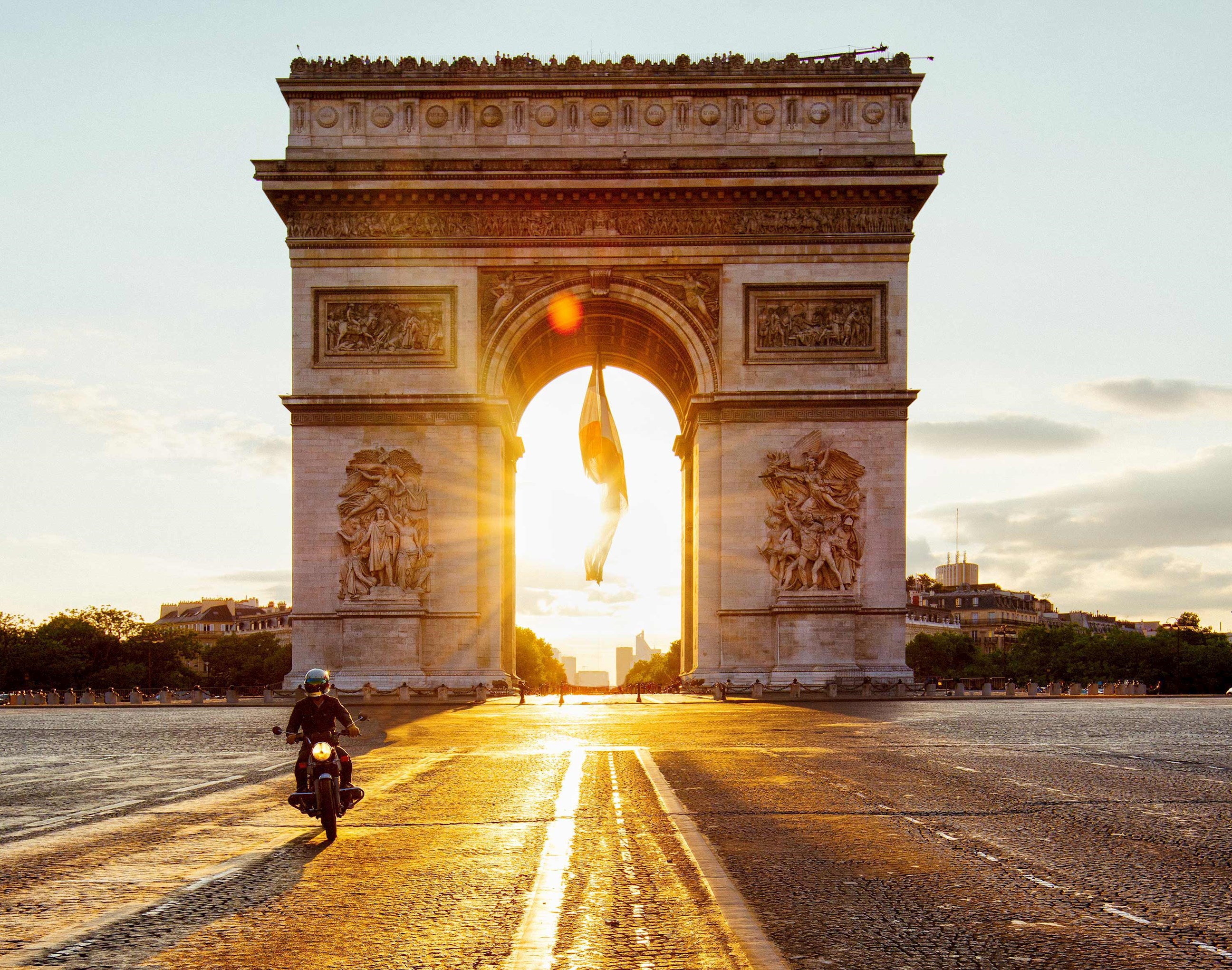 A sunset view of Arc De Triomphe in Paris, France