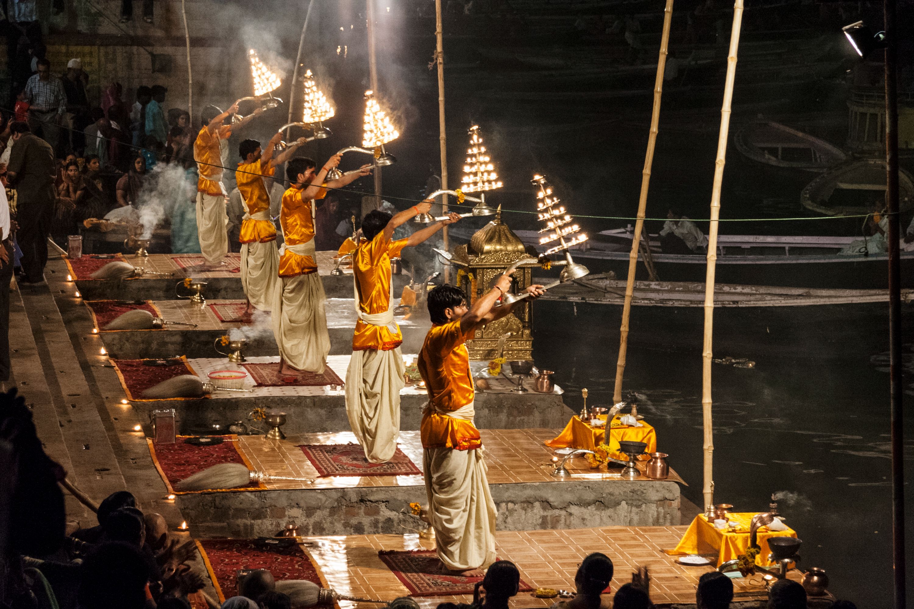People dressed in gold clothing participate in the Aarti ceremony on the Ganges River in India.