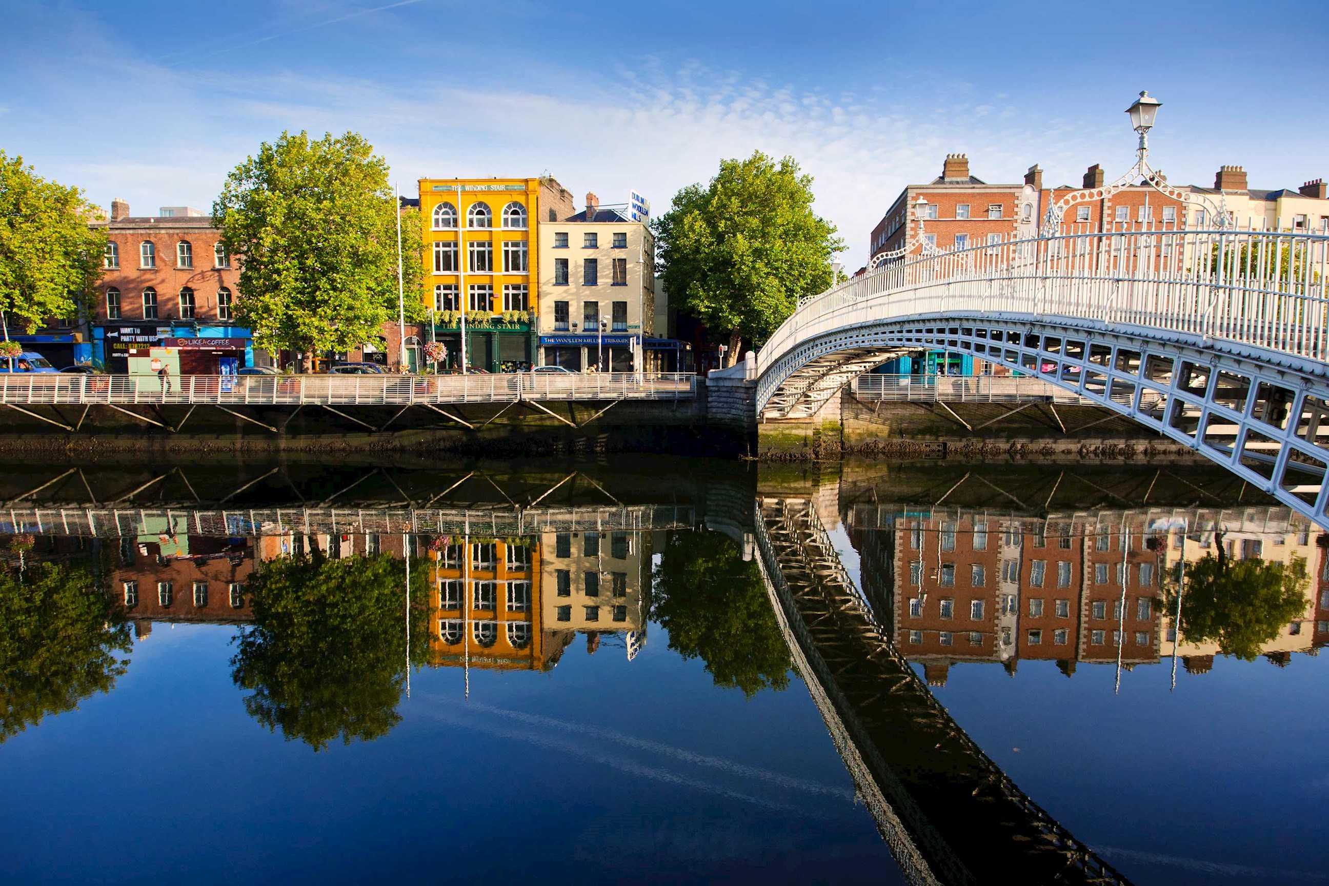 Sunny riverside view with historic bridge in Dublin, Ireland