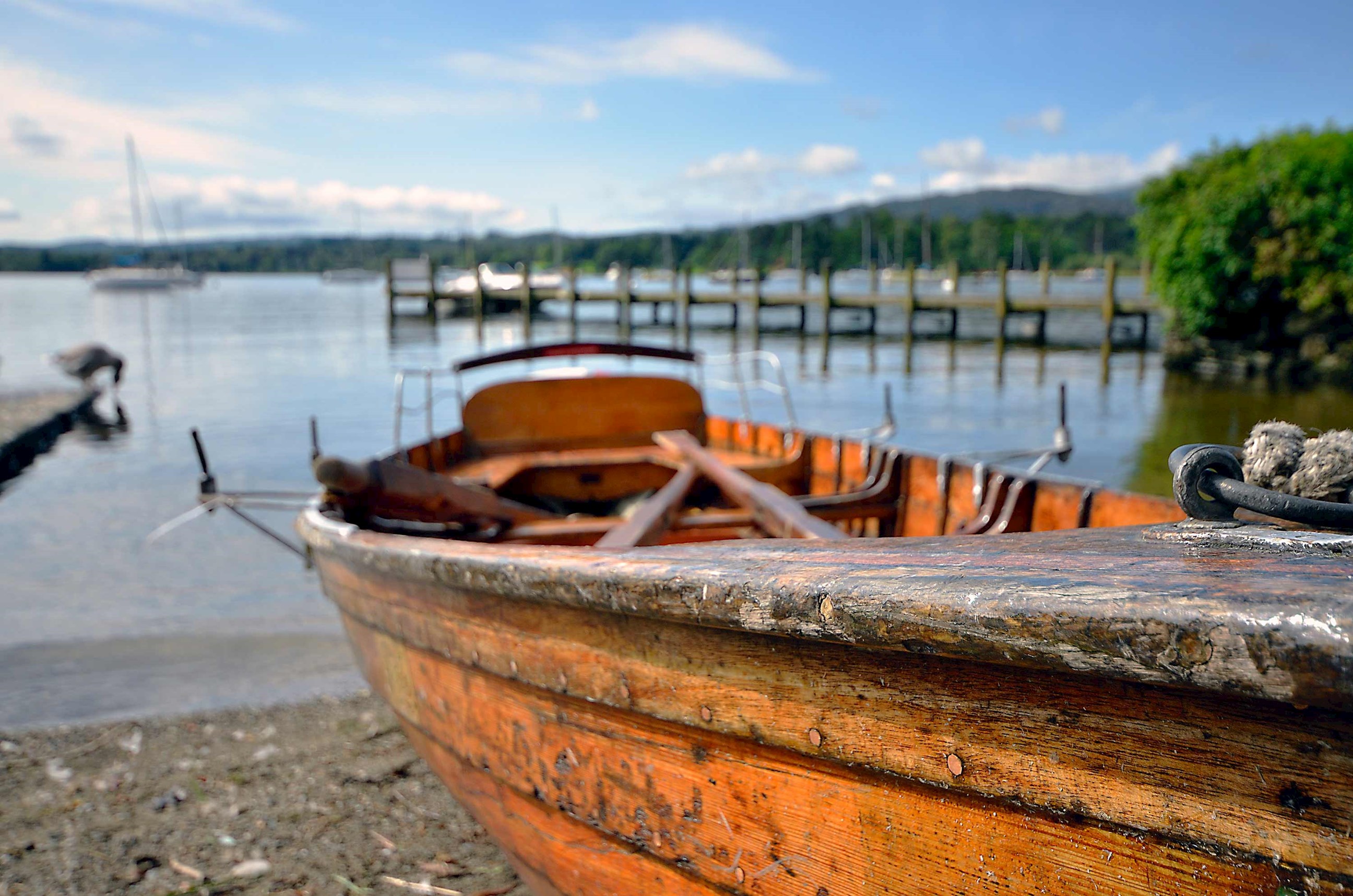 A close up of a wooden boat near the pier in Lake District, England