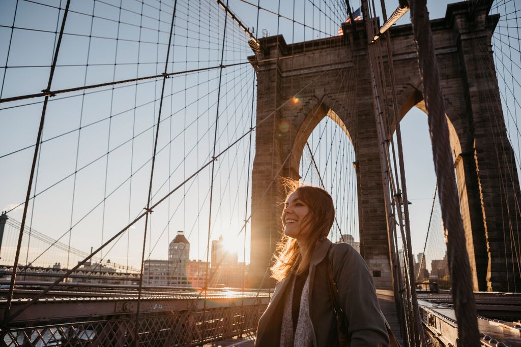 Usa New York New York City Female Tourist On Brooklyn Bridge At Sunrise
