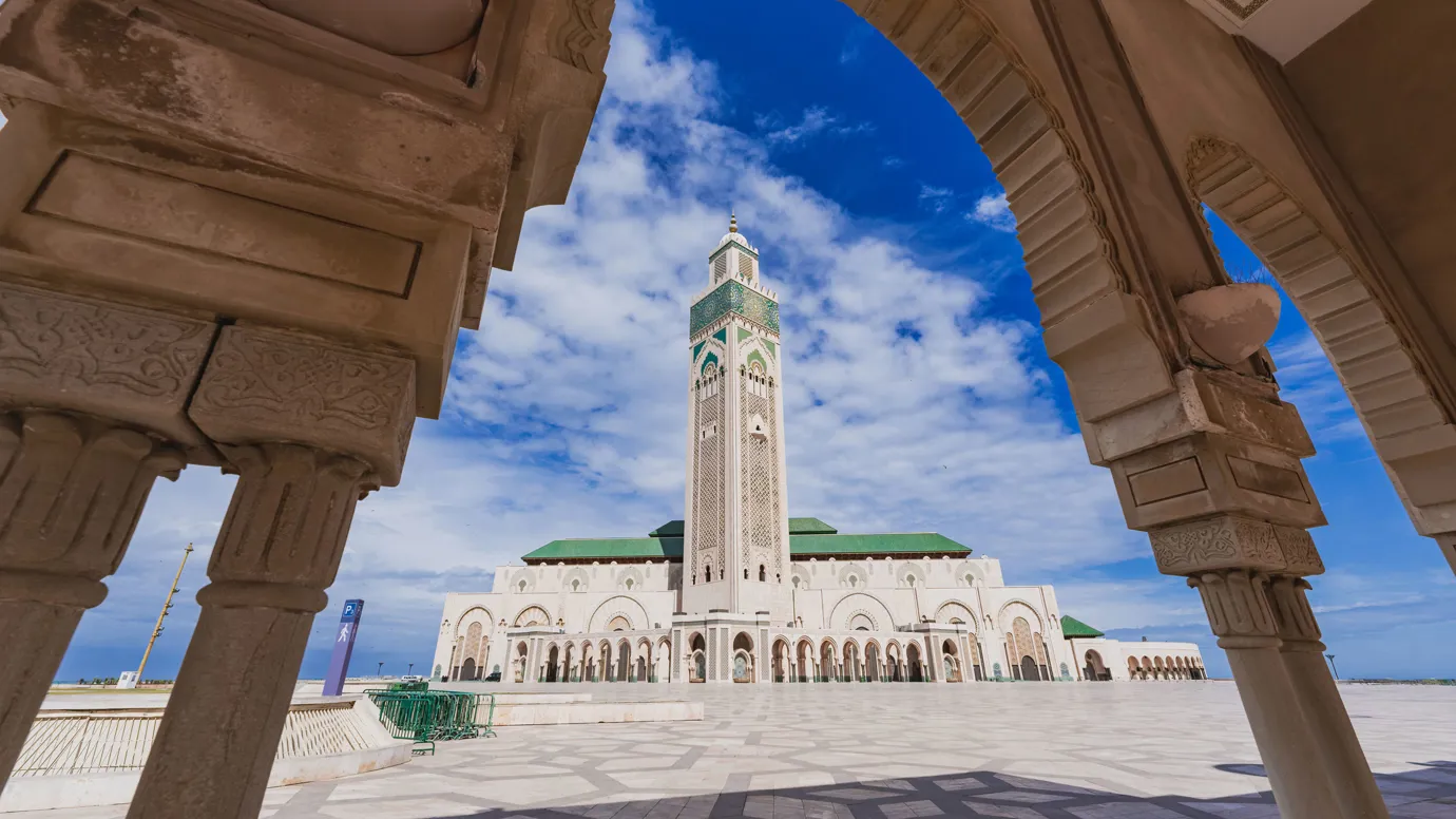 Hassan II Mosque framed by ornate arch in Casablanca, Morocco