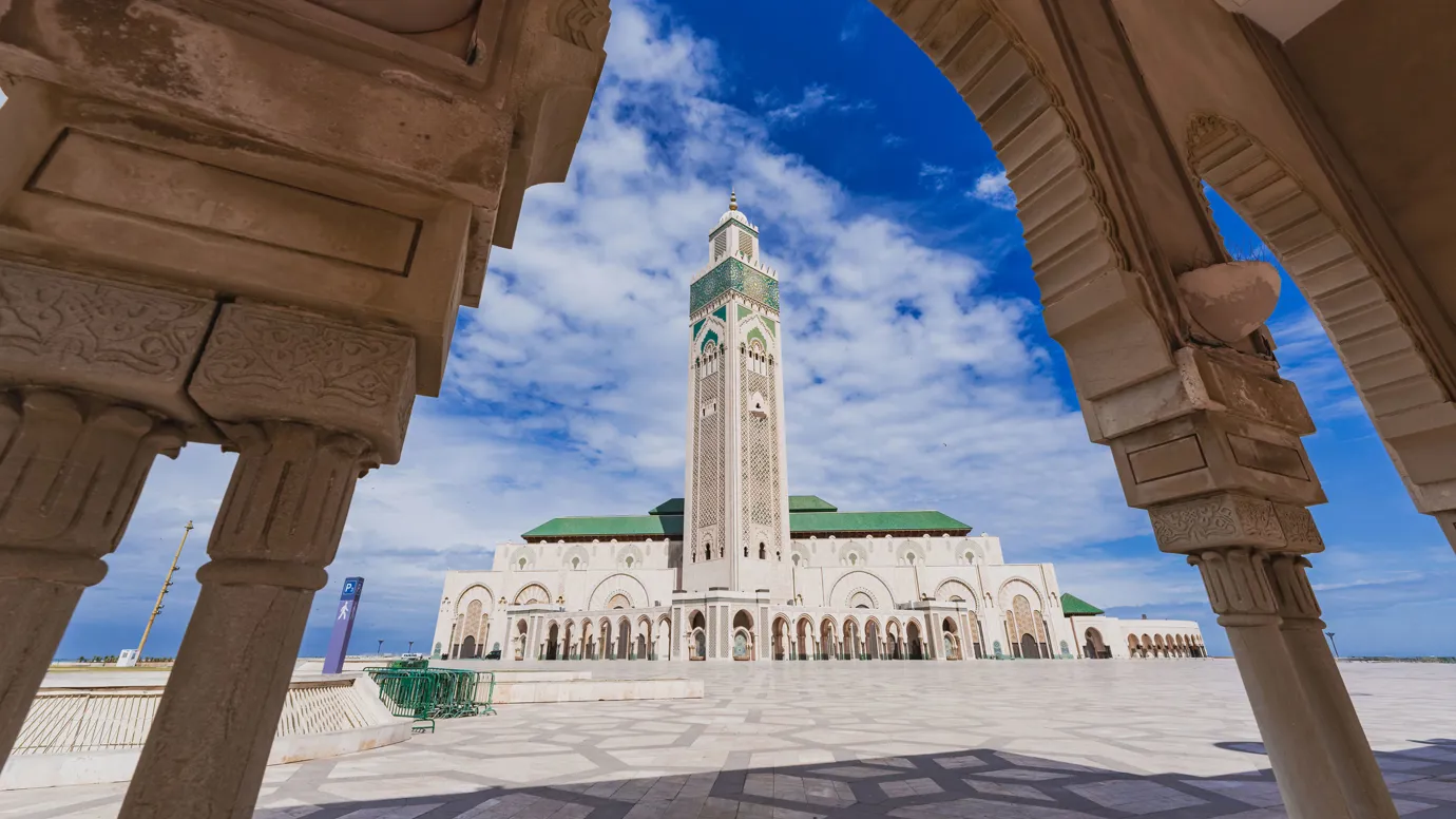 Hassan II Mosque framed by ornate arch in Casablanca, Morocco