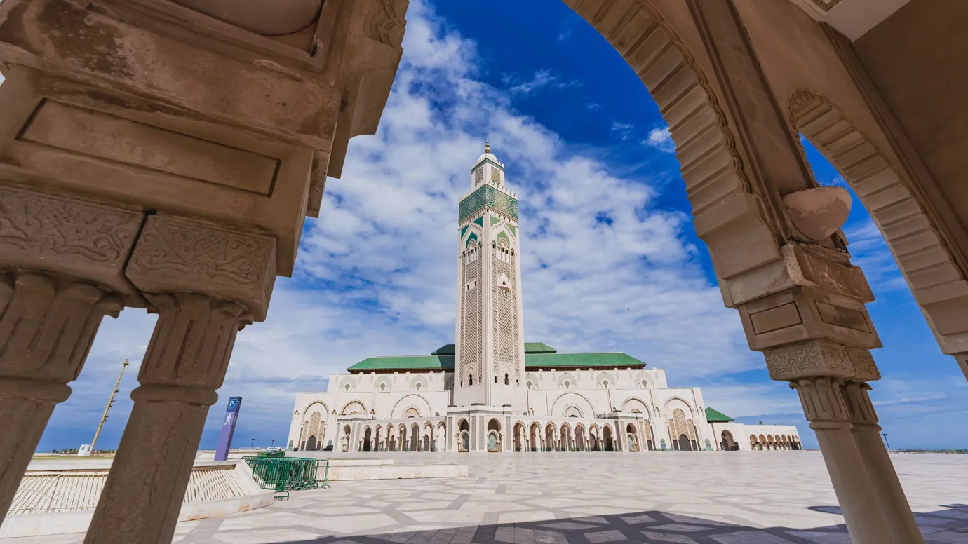 Hassan II Mosque framed by ornate arch in Casablanca, Morocco