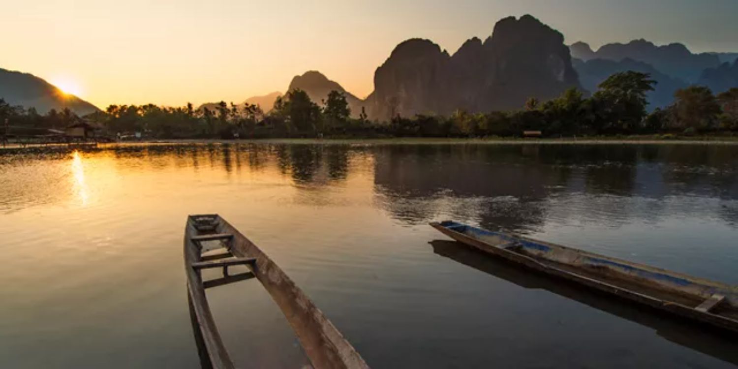 Mekong River at sunset with wooden boats in the foreground, Thailand