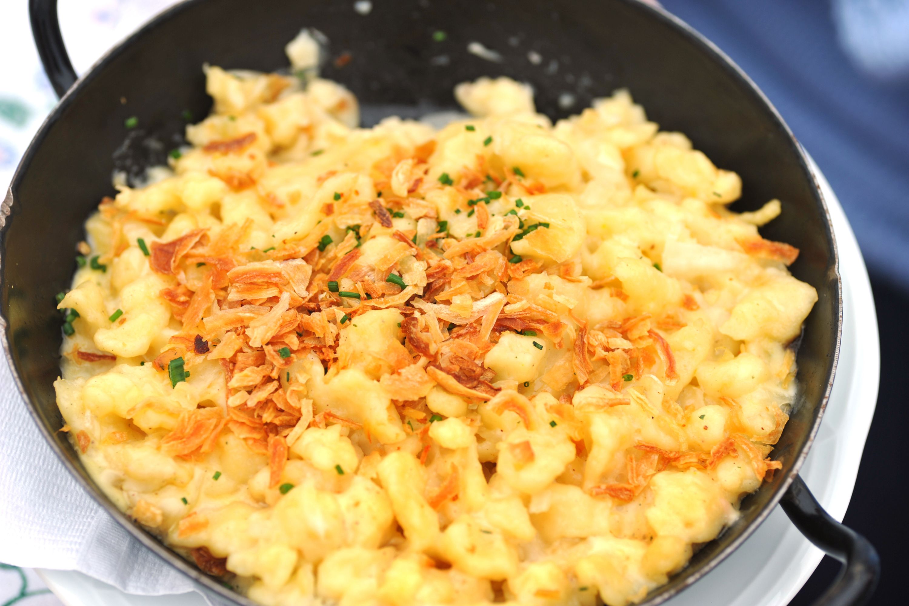 A bowl of cheesy Kasespatzle, a traditional dish from Austria