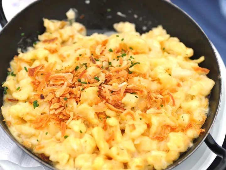 A bowl of cheesy Kasespatzle, a traditional dish from Austria