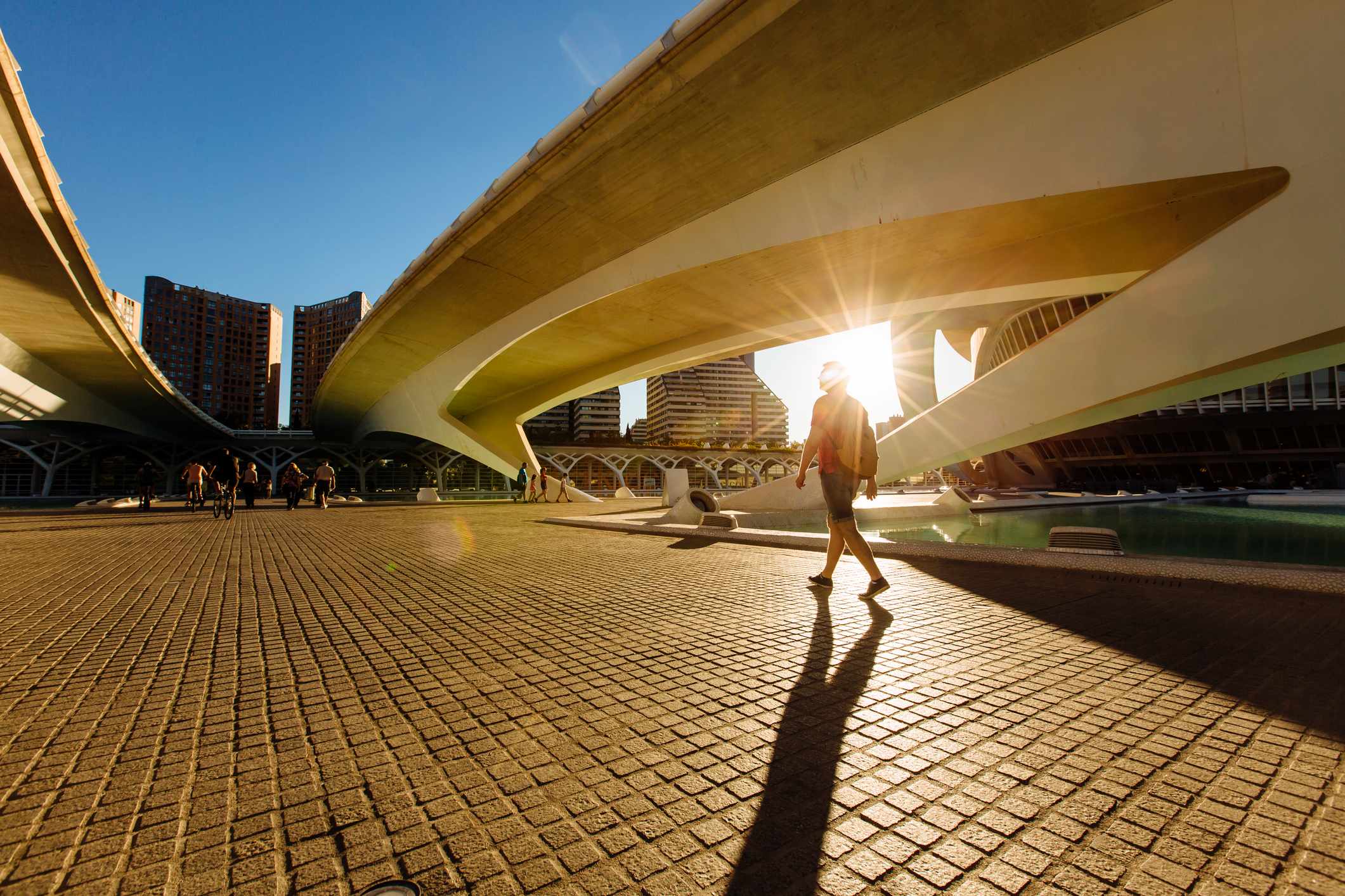 Silhouetted man in shorts walking around Valencia's City of Arts and Sciences