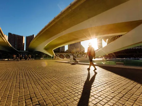 Silhouetted man in shorts walking around Valencia's City of Arts and Sciences