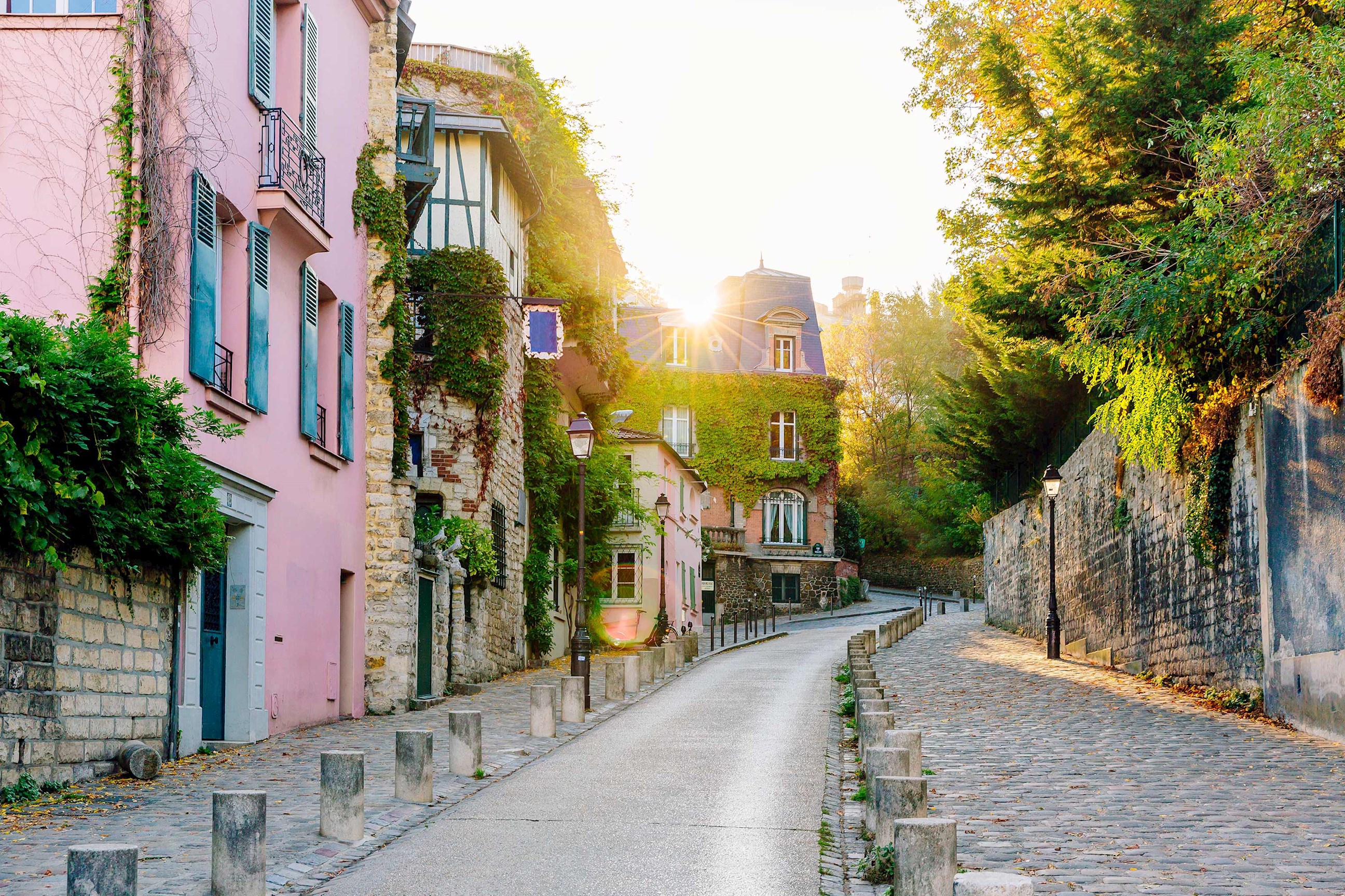 External view of a cobblestone street on a sunny day in Paris, France