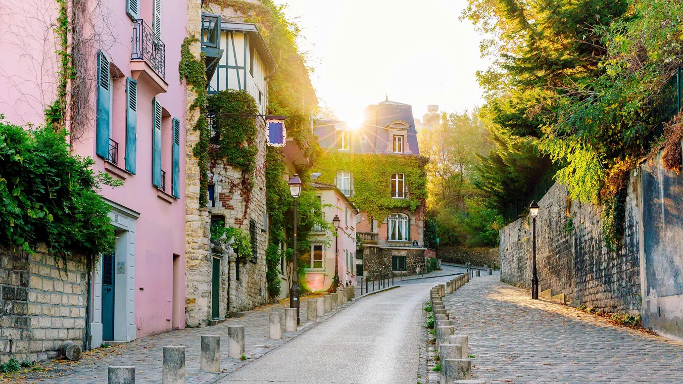 External view of a cobblestone street on a sunny day in Paris, France