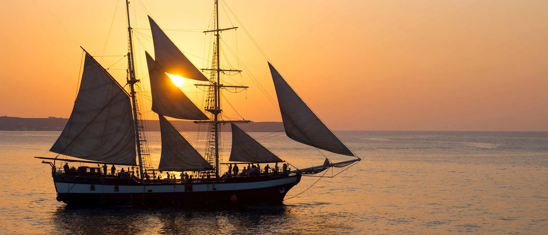 Boat in the sea in front of a beautiful sunset