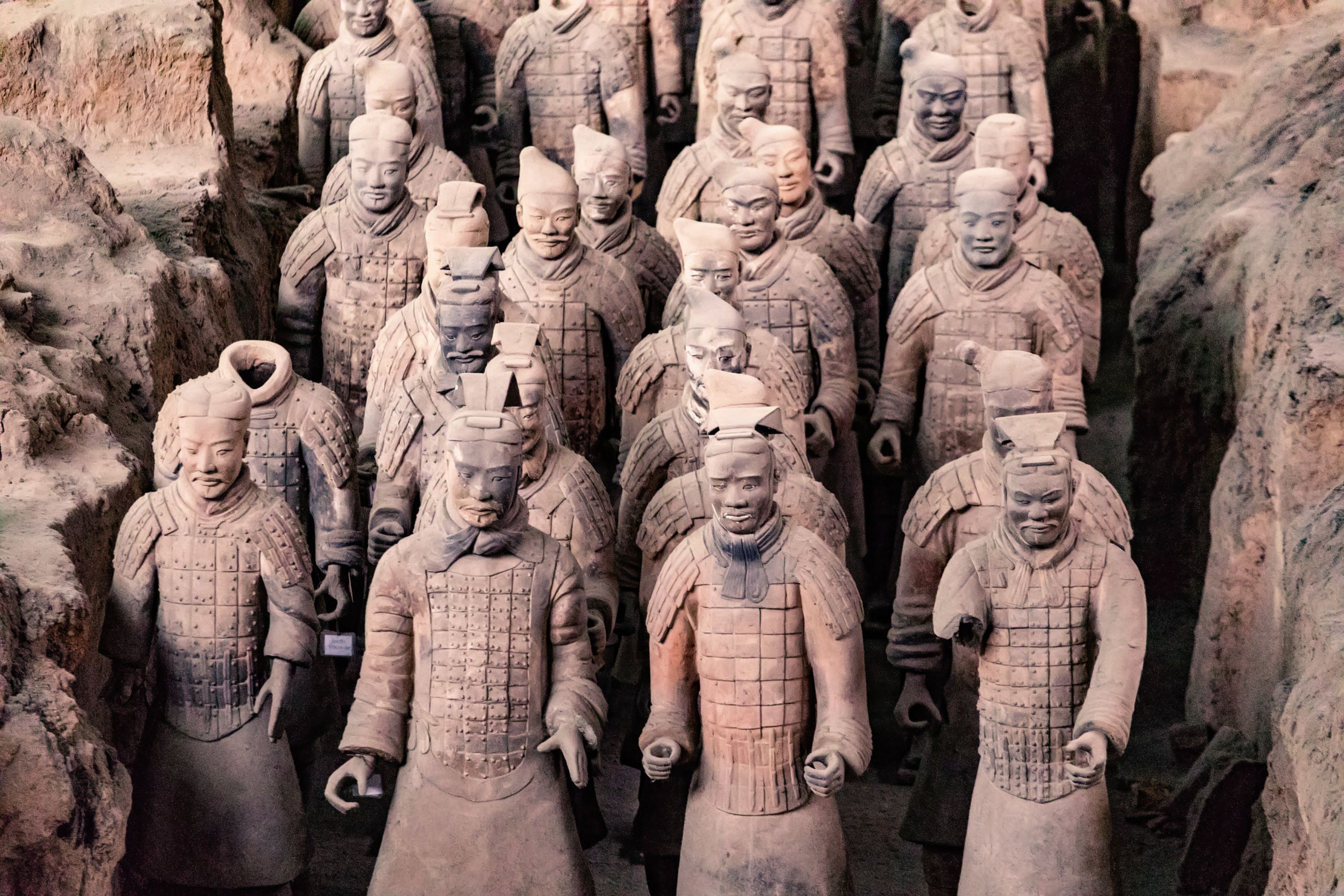 Rows of the famous terracotta warriors in China, carved wearing their traditional battle costumes.