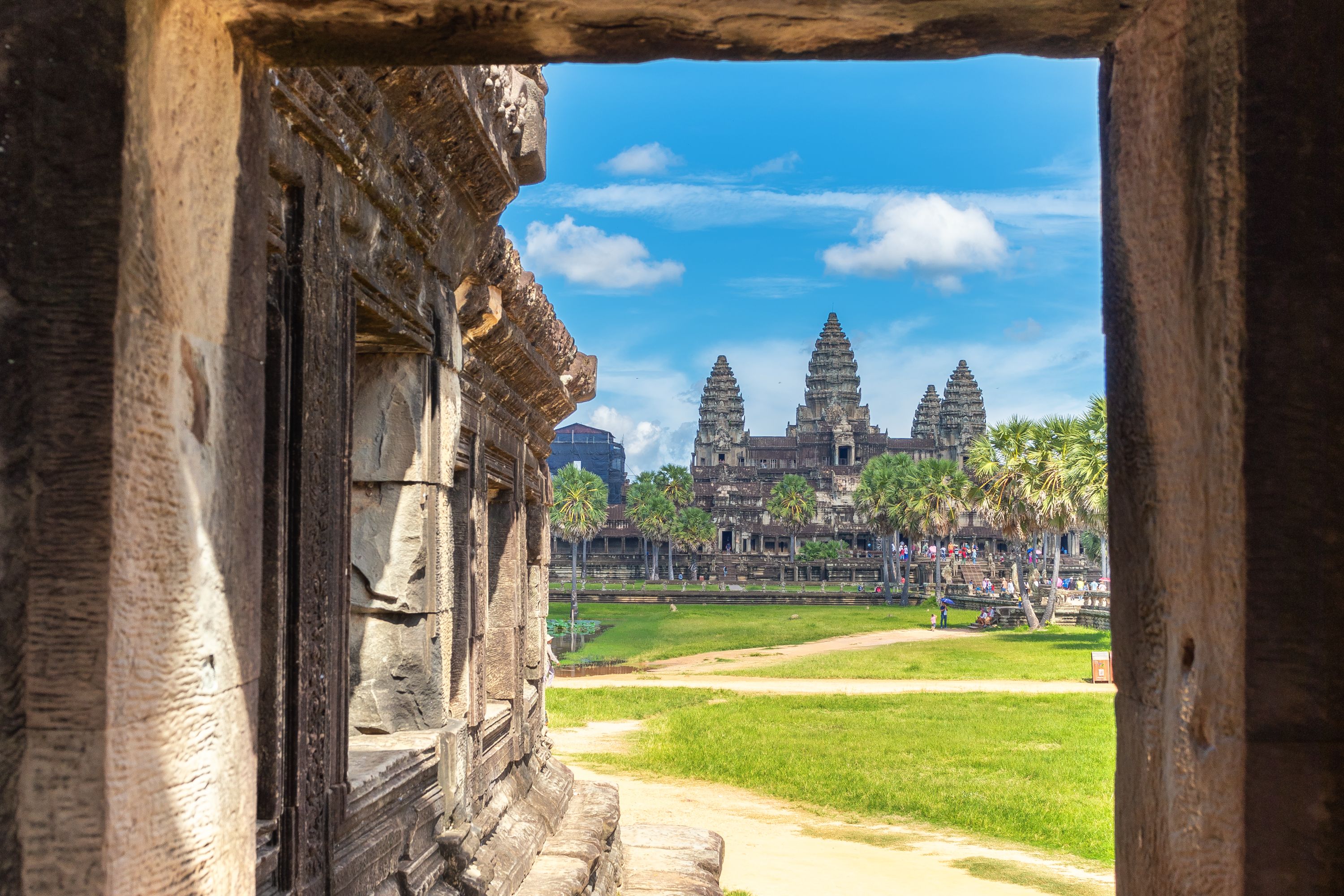 The towers of the temples of Angor Wat in Cambodia viewed through a stone window