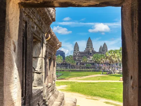 The towers of the temples of Angor Wat in Cambodia viewed through a stone window