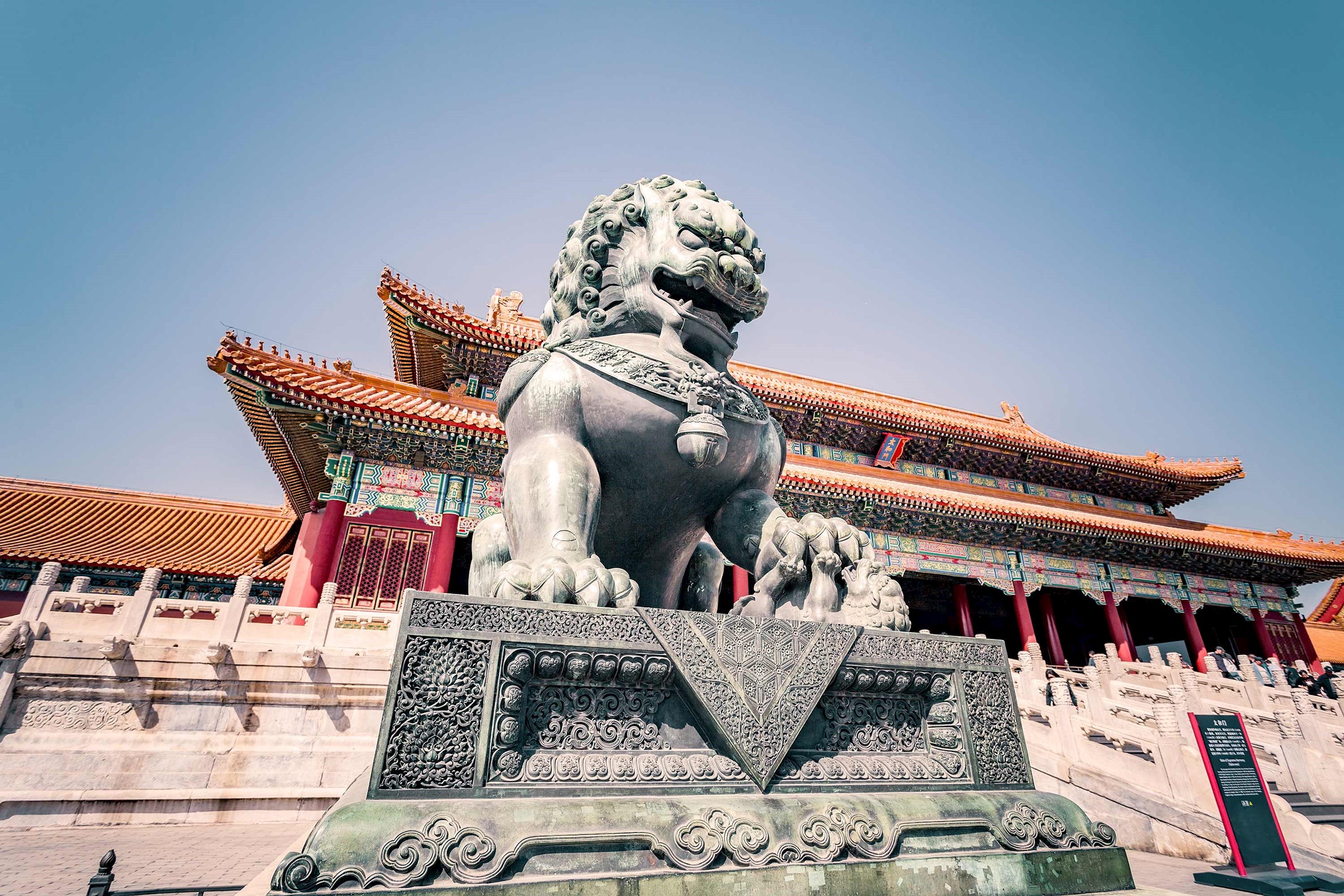 Bronze lion statue guarding entrance of Forbidden City in Beijing, China
