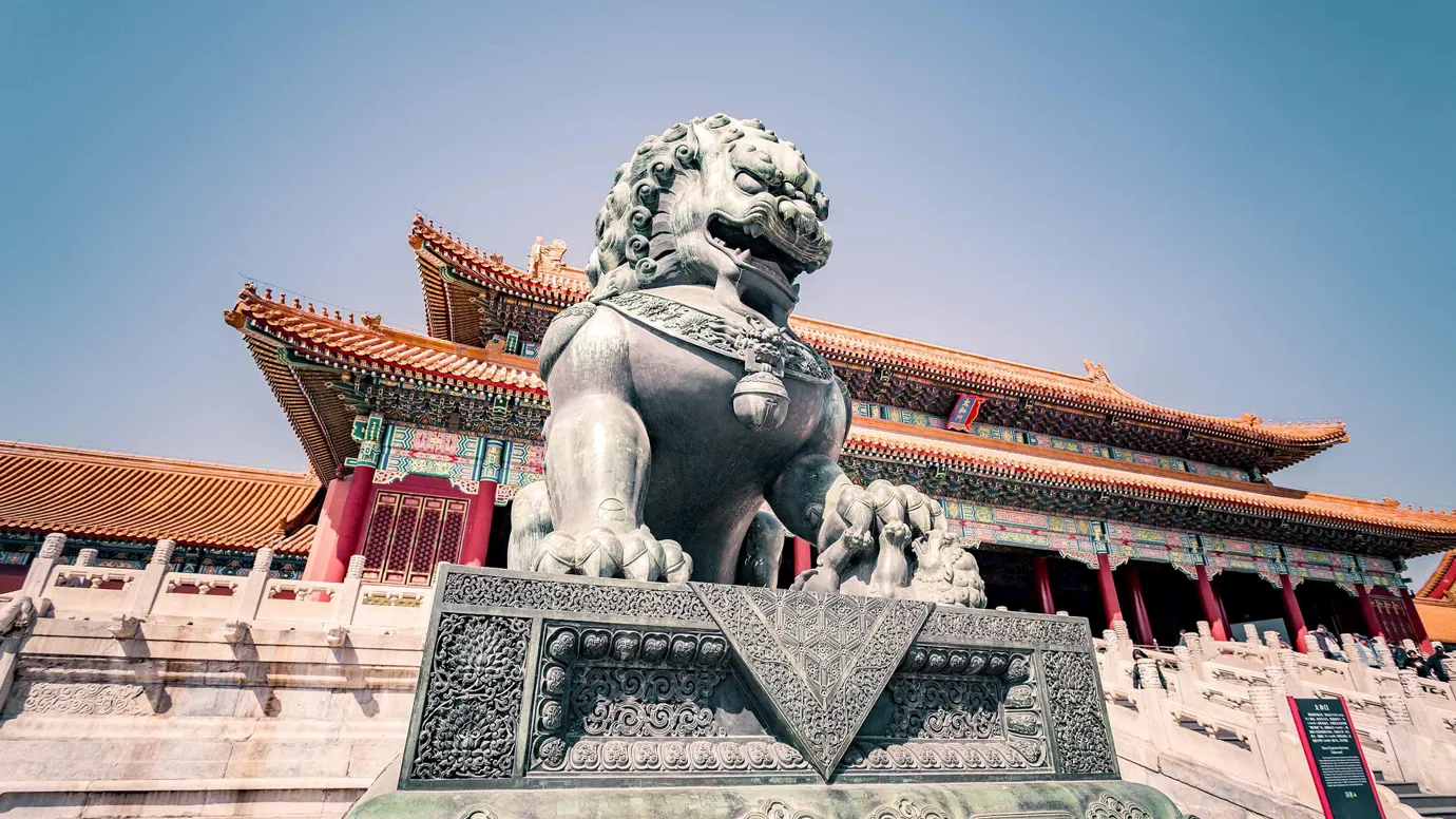 Bronze lion statue guarding entrance of Forbidden City in Beijing, China