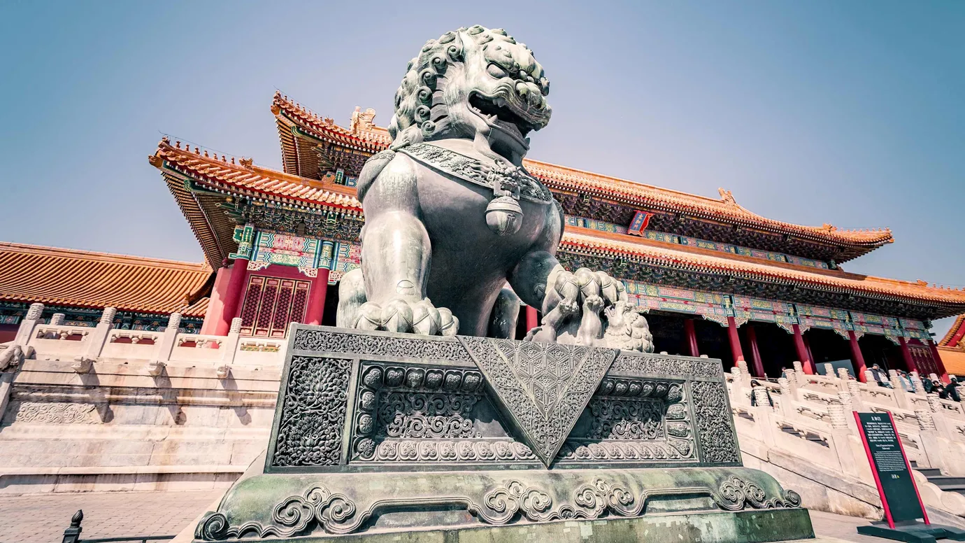 Bronze lion statue guarding entrance of Forbidden City in Beijing, China