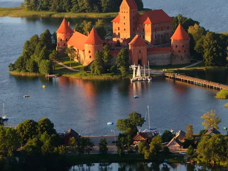 An island with a castle in the middle of a lake Lithuania Trakai