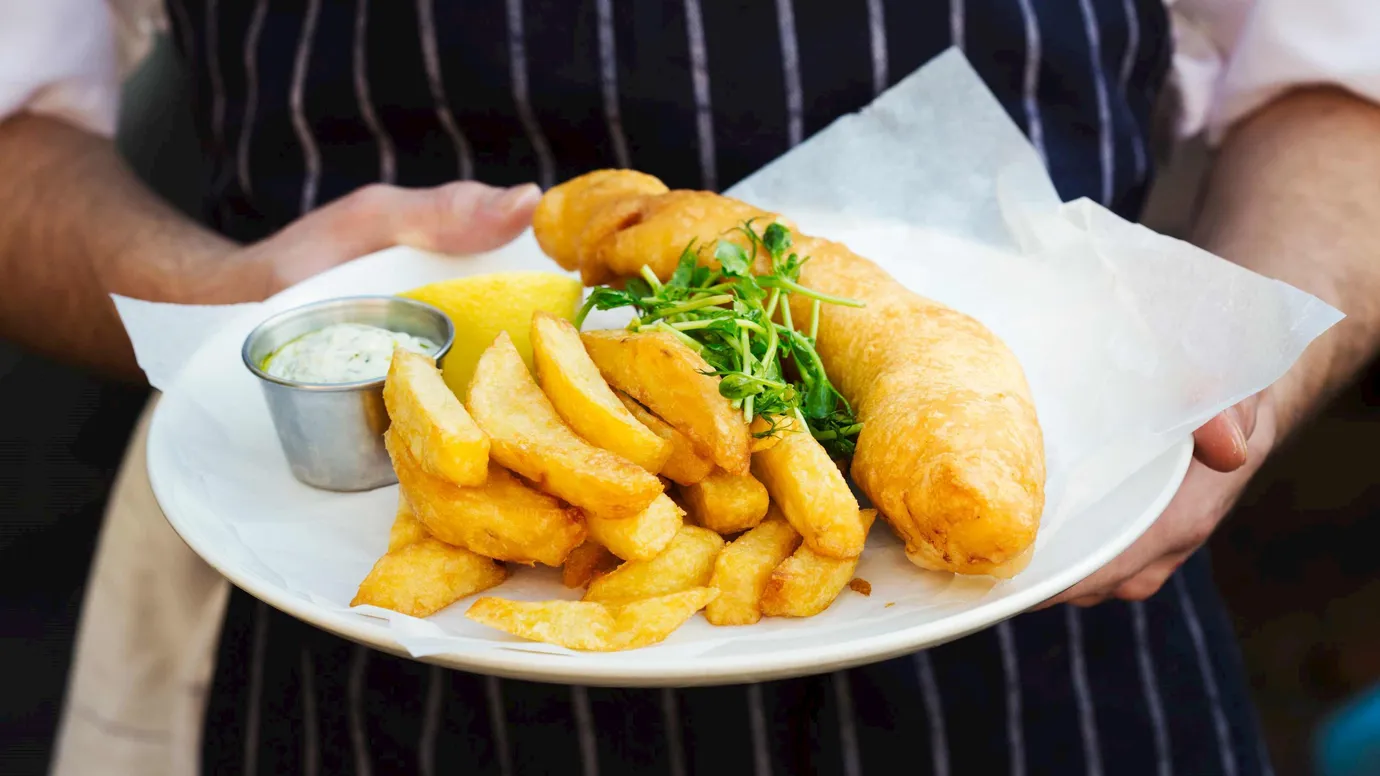 Man with Fish and Chips in London, England