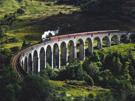Glenfinnan Viaduct in Scotland with steam train on, famous from Harry Potter