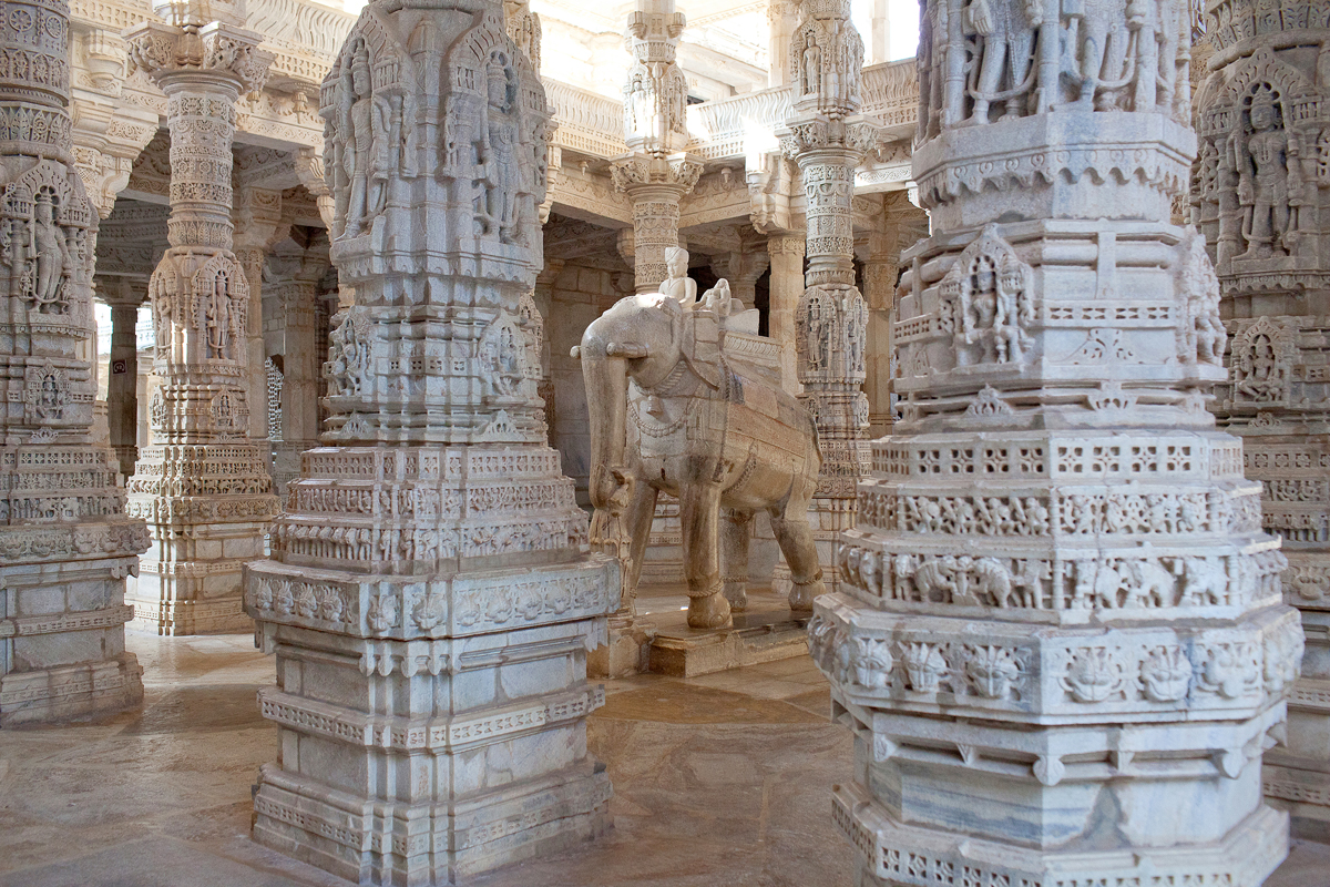 Intricately carved marble pillars and elephant sculpture inside Ranakpur Jain Temple, India