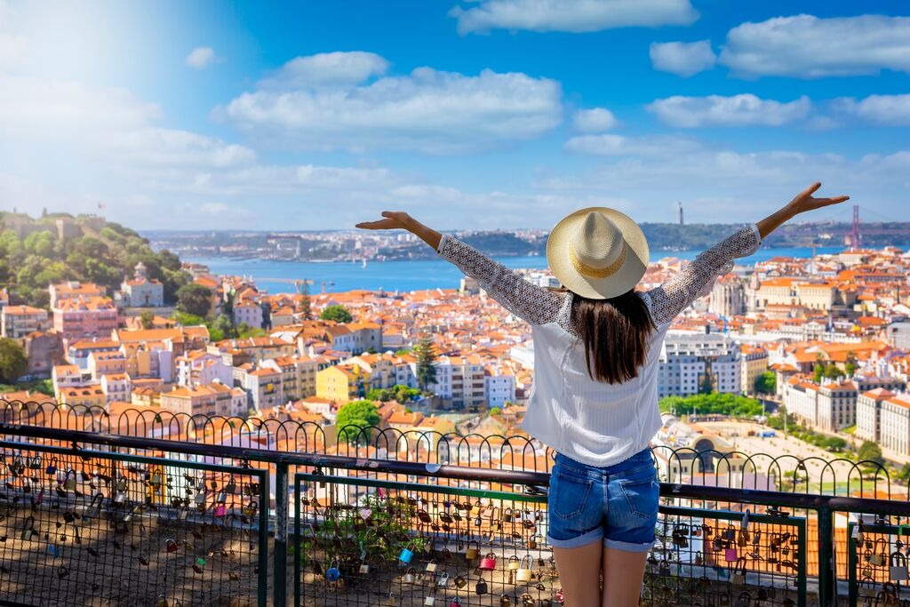 a-happy-tourist-woman-overlooks-the-colorful-old-town-alfama-of-lisbon-city.jpg