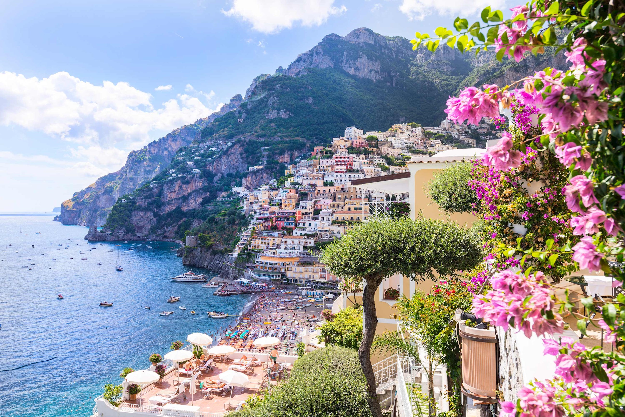Positano on the Amalfi Coast with colourful houses and pink flowers