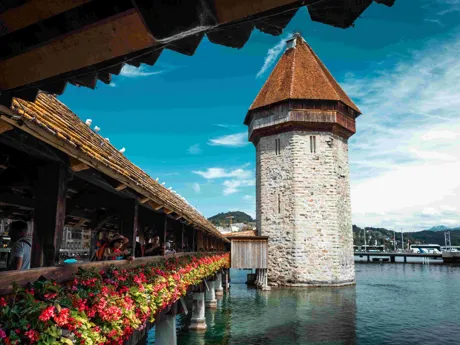 Wooden Bridge in Lucerne, Switzerland, with flowers running along the outside