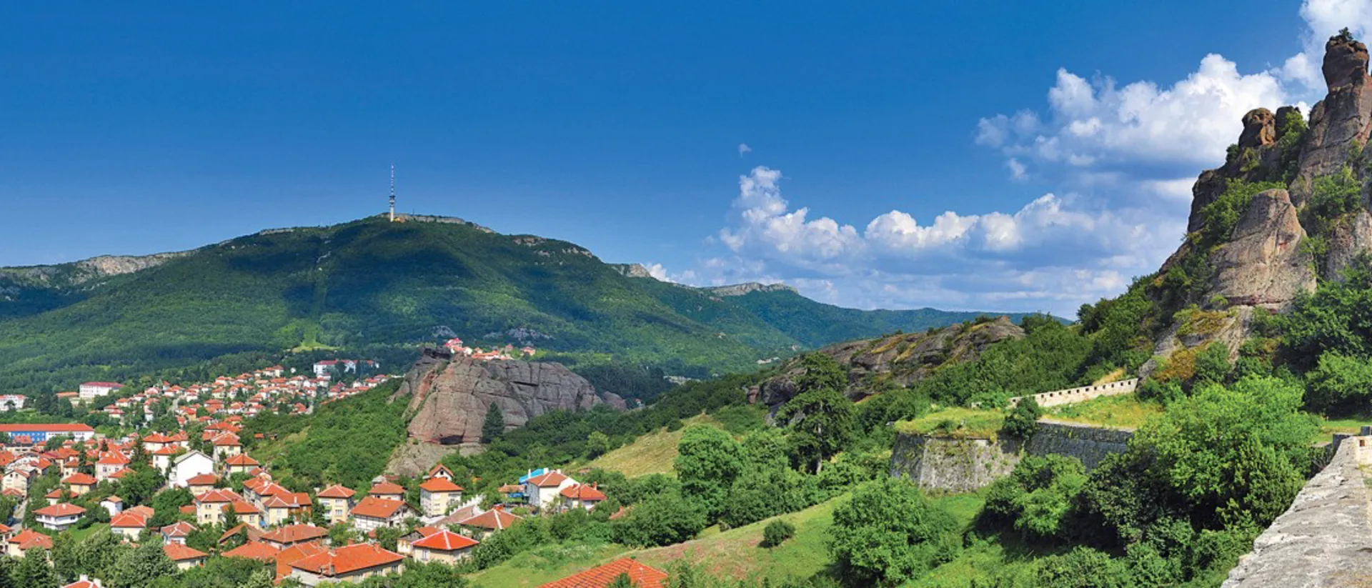 A scenic view of a city with mountains in the background in Belogradchi
