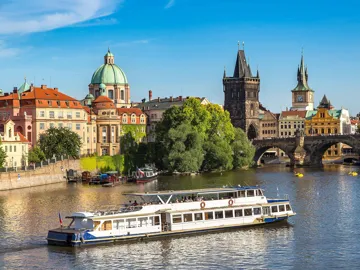 A scenic view of colourful buildings and a river in Prague, Czech Republic