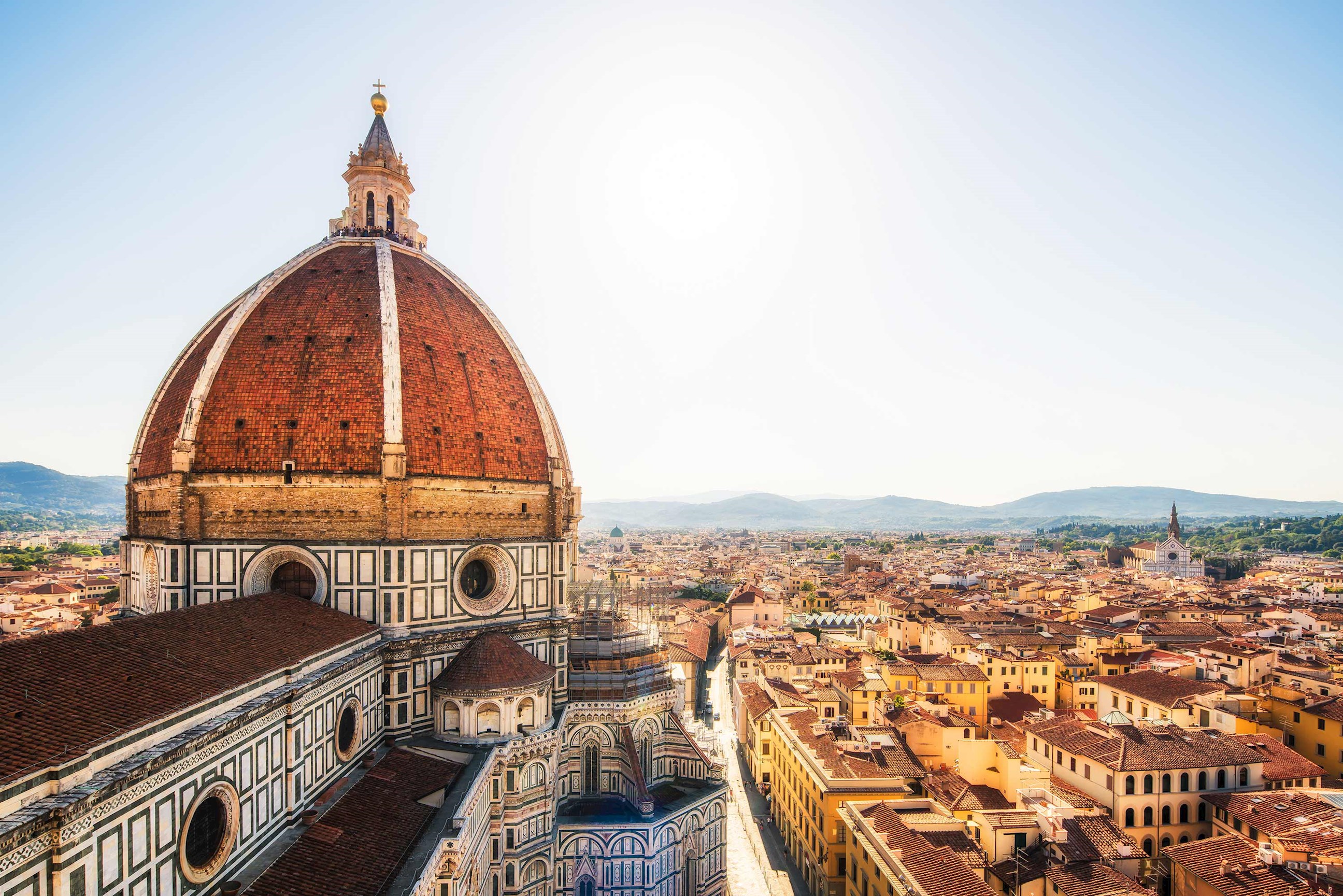 A view of Duomo Santa Maria del Fiore under a bright afternoon sun in Florence, Italy