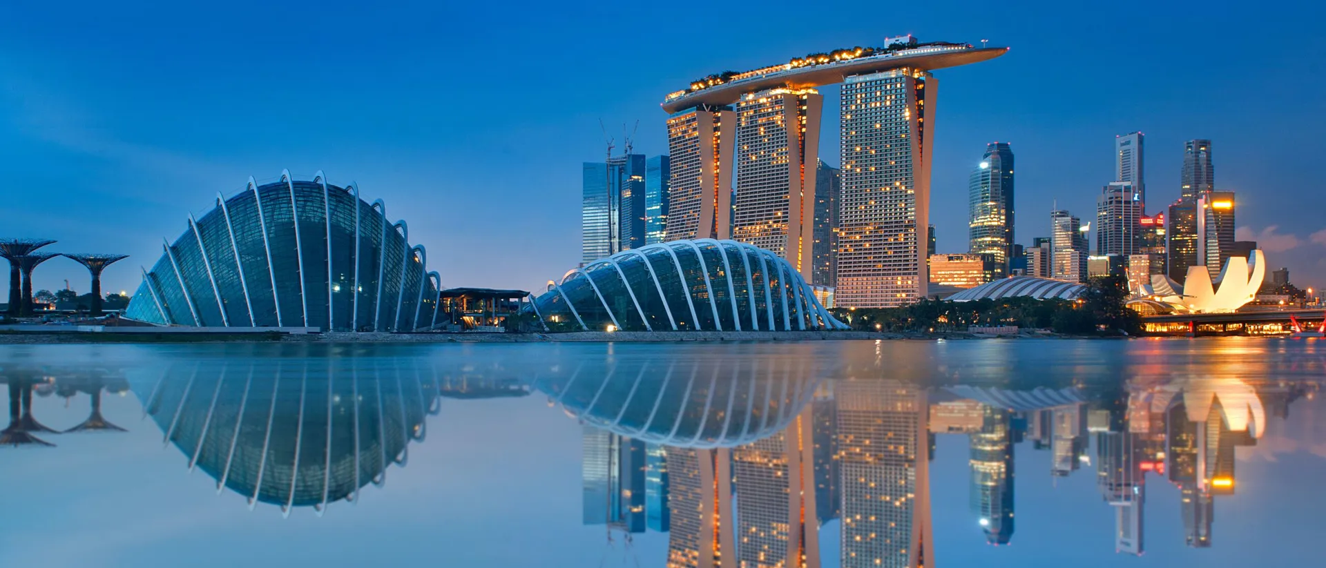 Reflections of modern buildings in water a night, Gardens By The Bay, Singapore