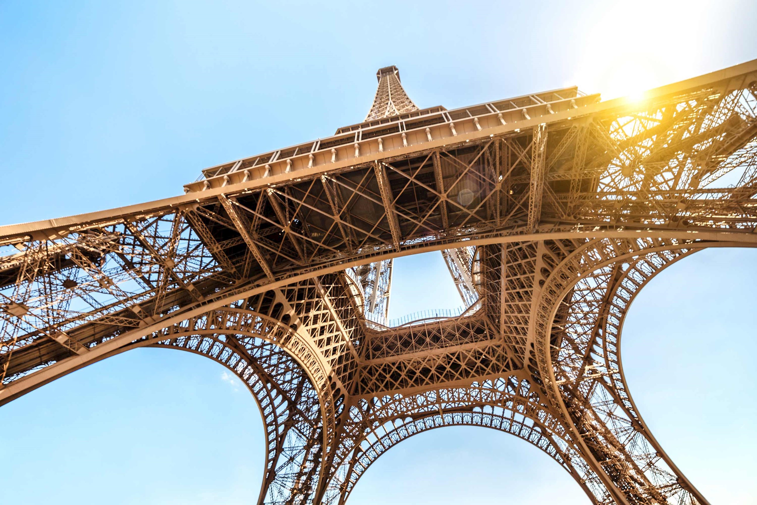 Iconic Eiffel Tower view from below against a clear sky in Paris, France