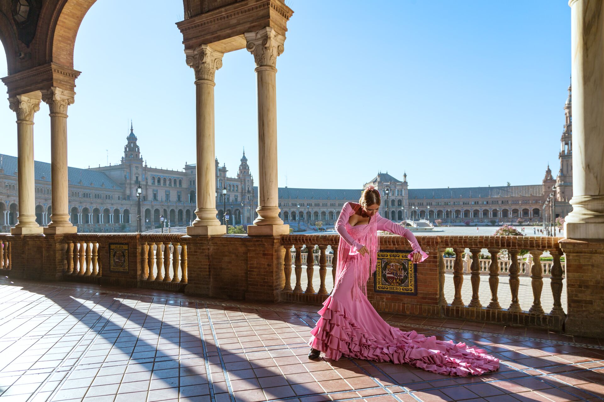 Flamenco Dancer in traditional pink dress performing outdoors in Spain