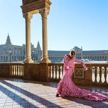 Flamenco Dancer in traditional pink dress performing outdoors in Spain