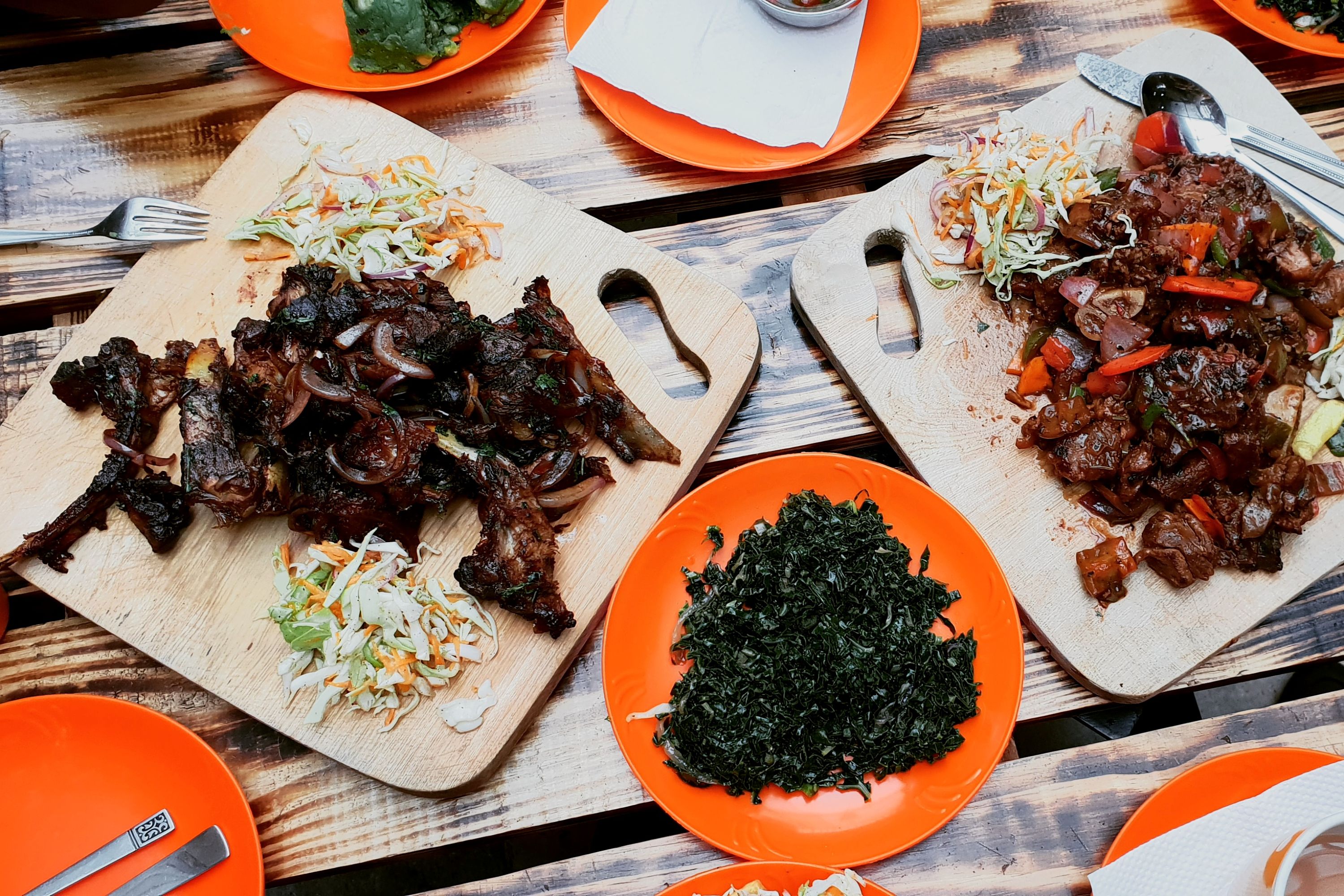 Plates of meat and vegetables cooked in a traditional Kenyan way