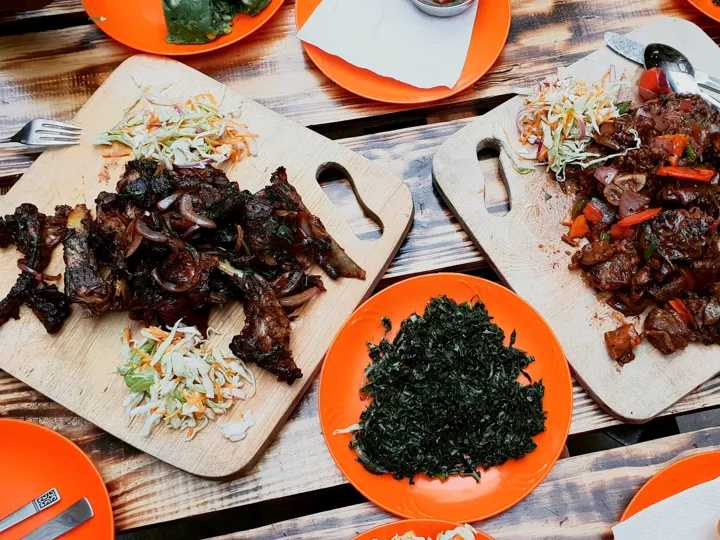 Plates of meat and vegetables cooked in a traditional Kenyan way