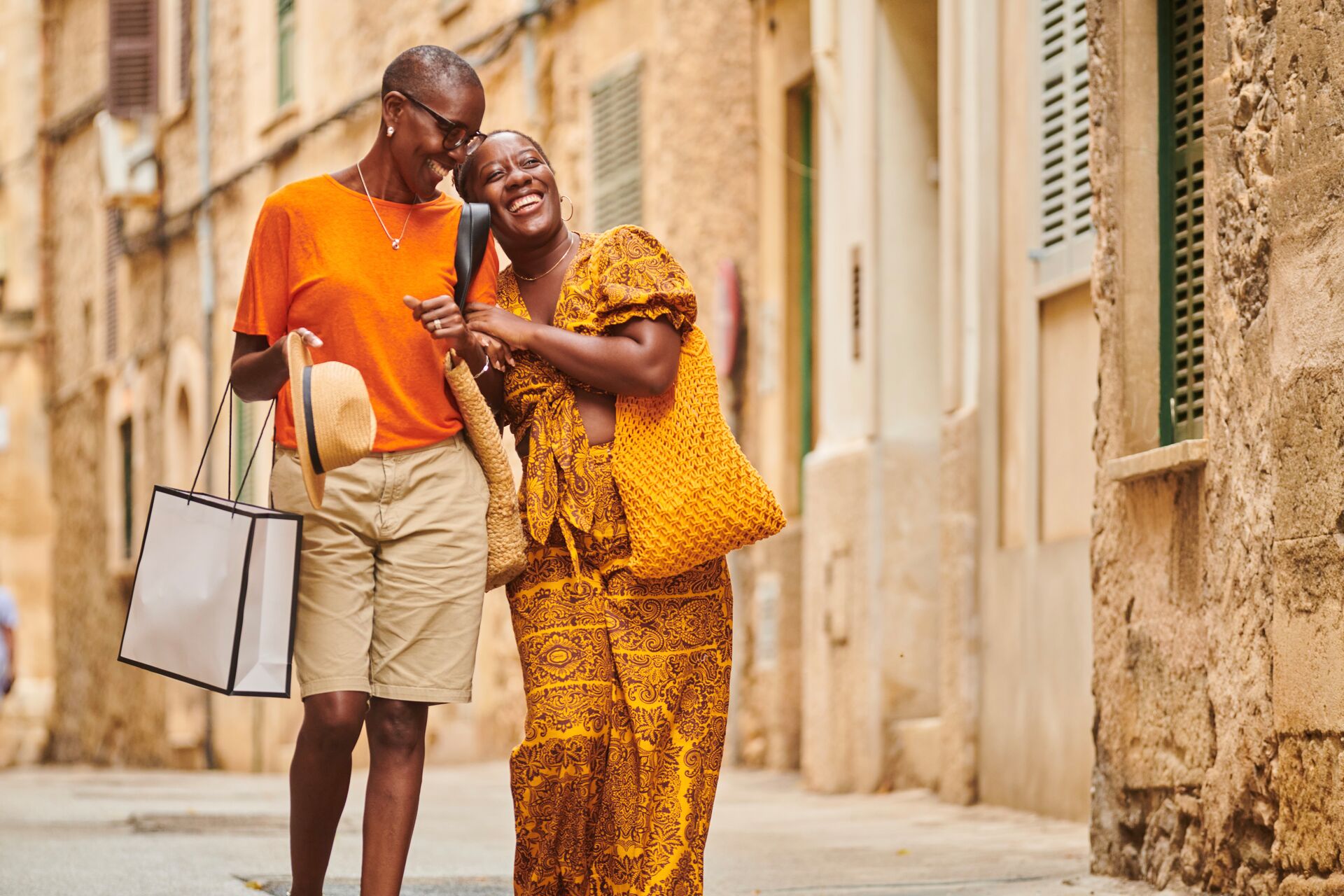 Women are smiling, hugging each other and walking through the ancient city