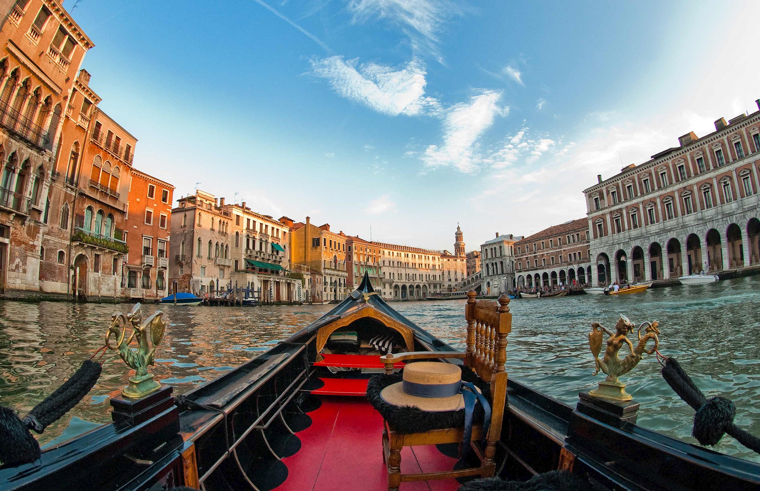 View from gondola navigating the canal with historic buildings in Venice, Italy