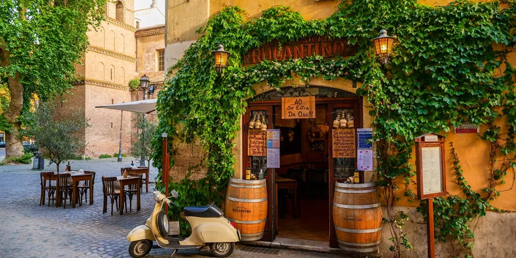 A Lovely Roman Restaurant In The Ancient Trastevere District With A Vintage Vespa