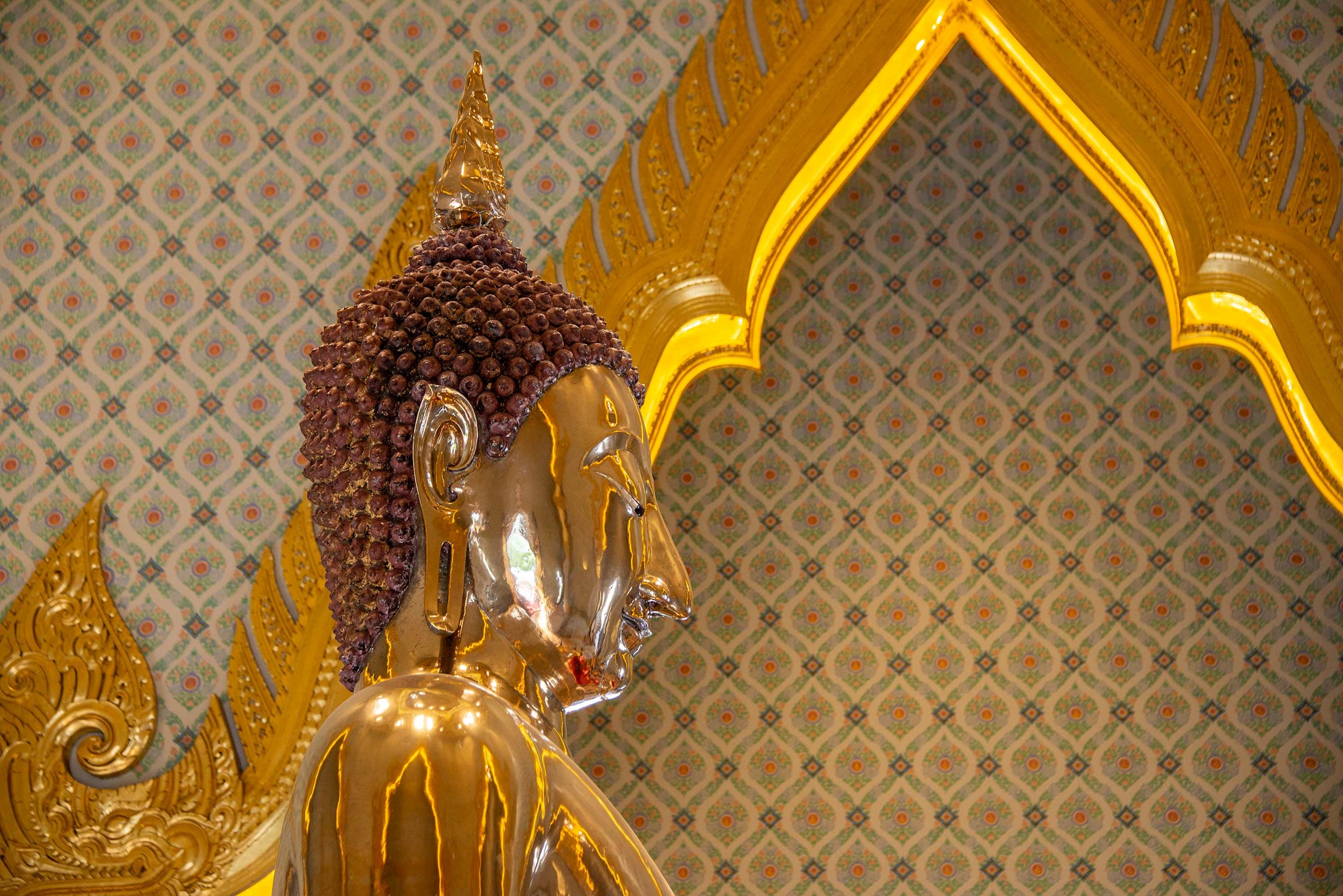 Close-up of Golden Buddha statue at Wat Traimit Temple in Bangkok, Thailand