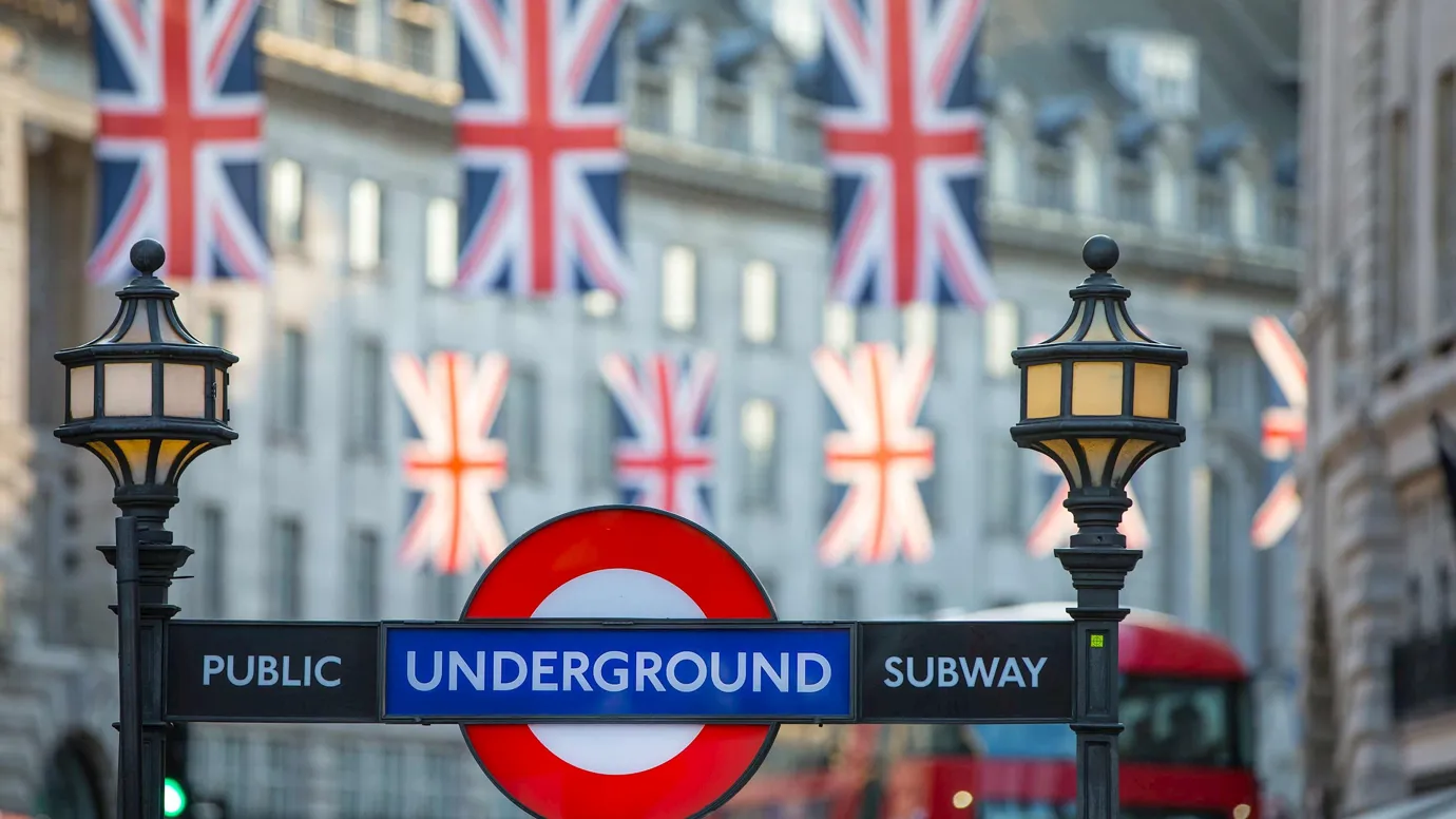 Flags hanging over streets and public sign in London, England
