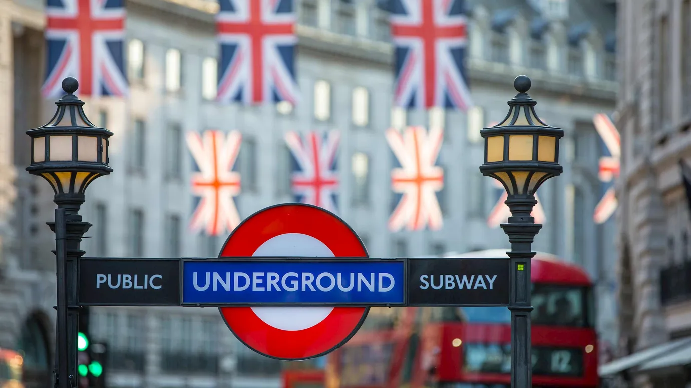 Flags hanging over streets and public sign in London, England