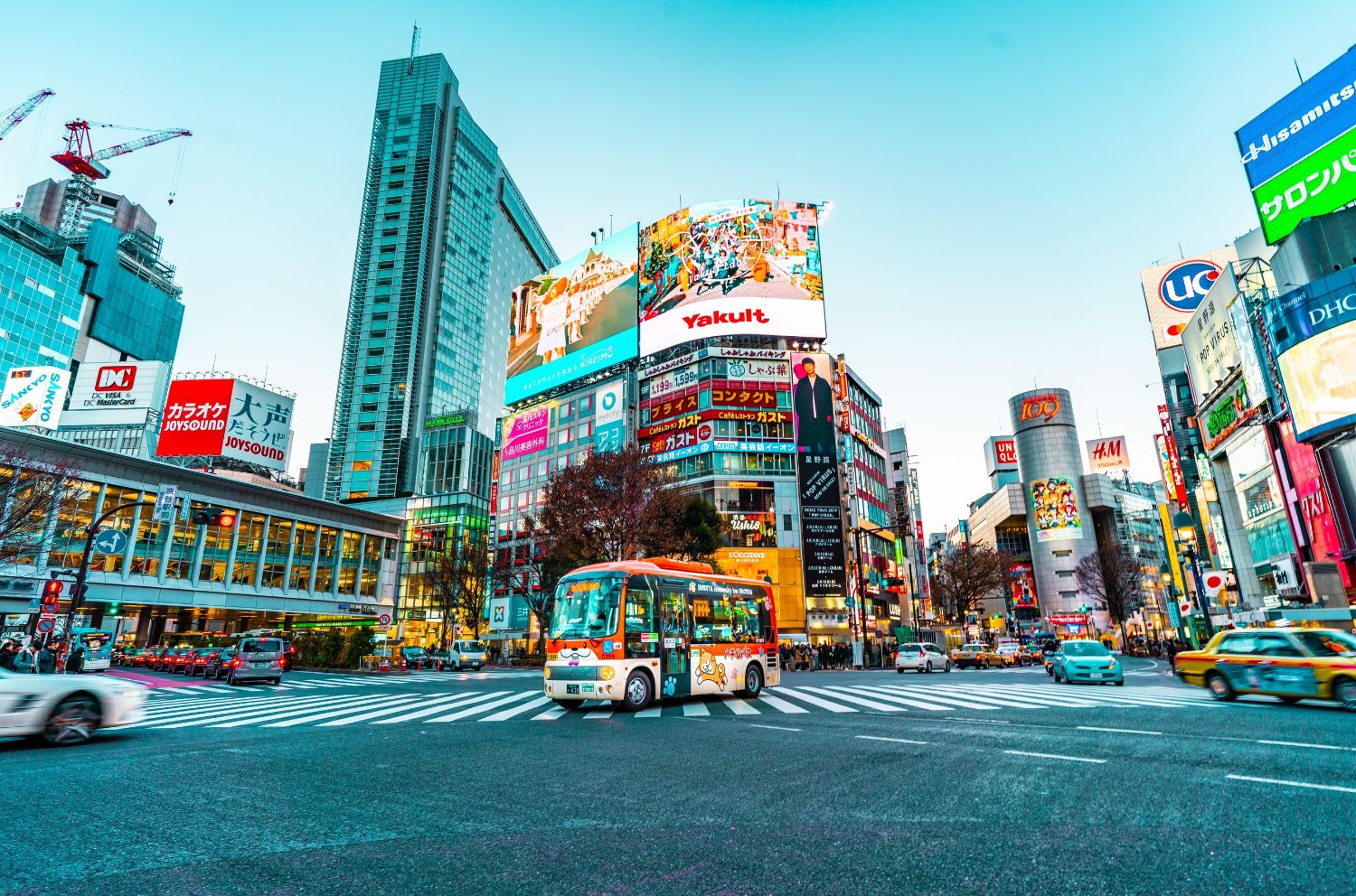 Colorful bus in foreground of Street City Center scene Tokyo Japan