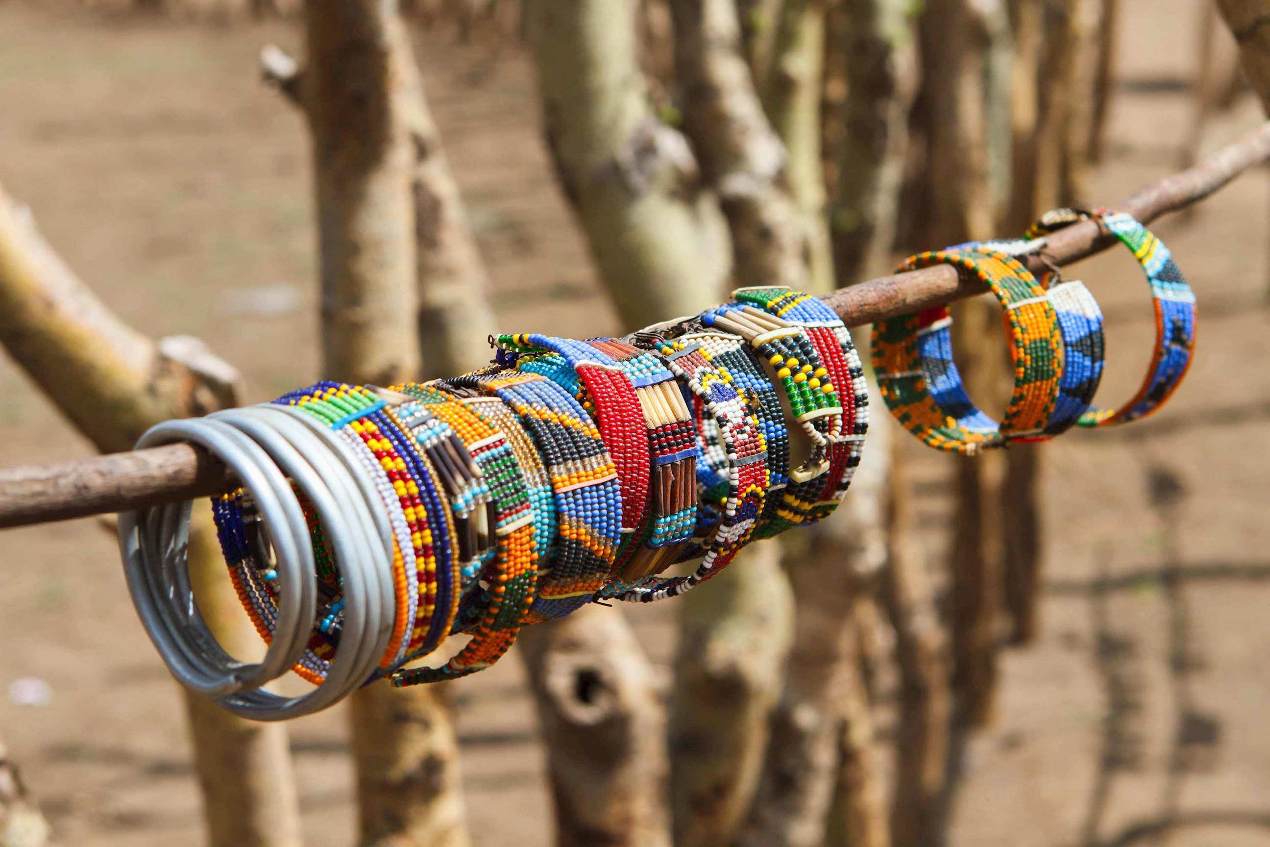 Colourful Maasai beaded bracelets displayed on wooden stick in Kenya