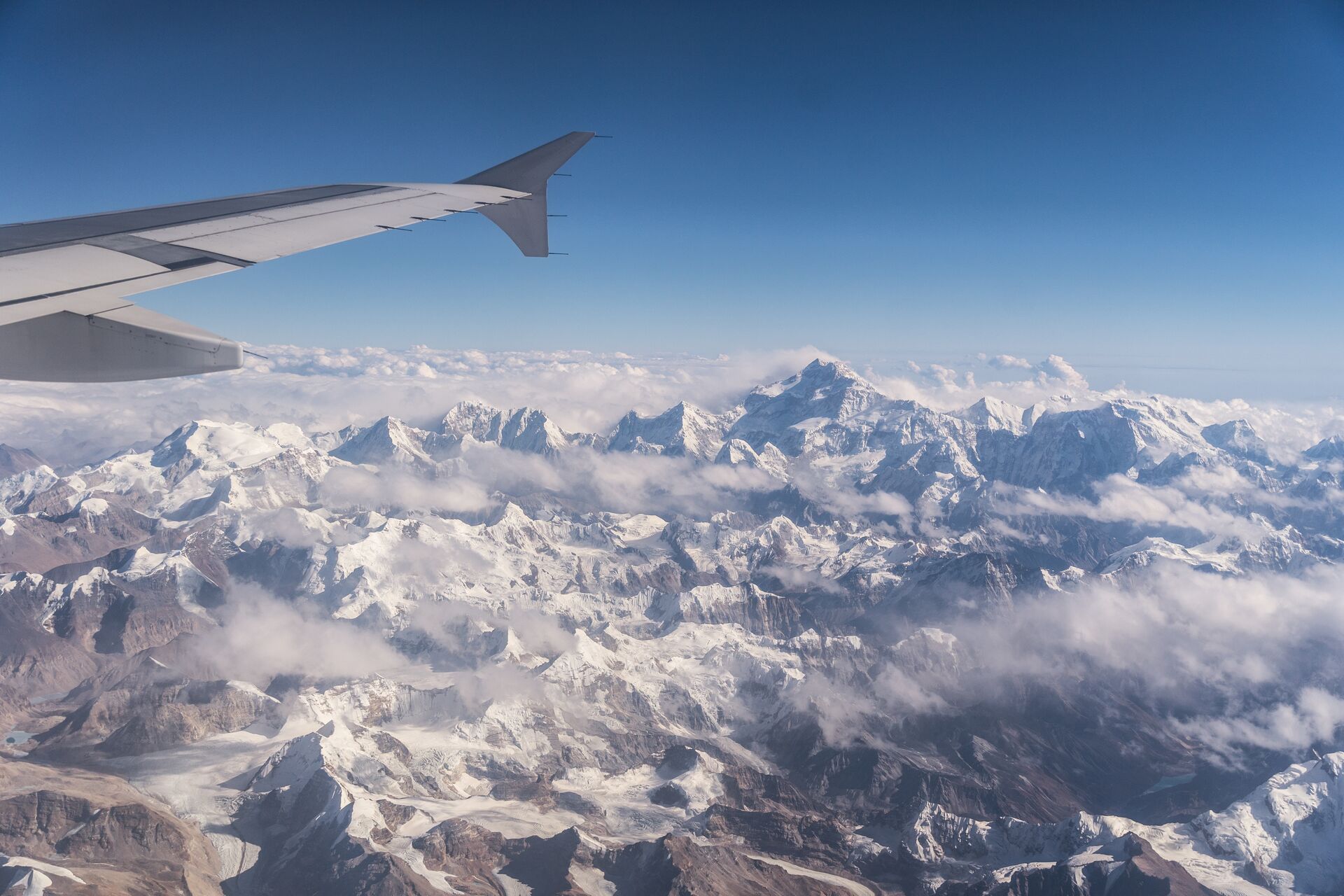 large-flying-over-the-himalayas-between-nepal-and-tibet-with-the-kangchenjunga-mountain-in-the-background-1088051194.jpg