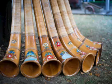 Traditional Swiss alphorns decorated with floral and flag motifs