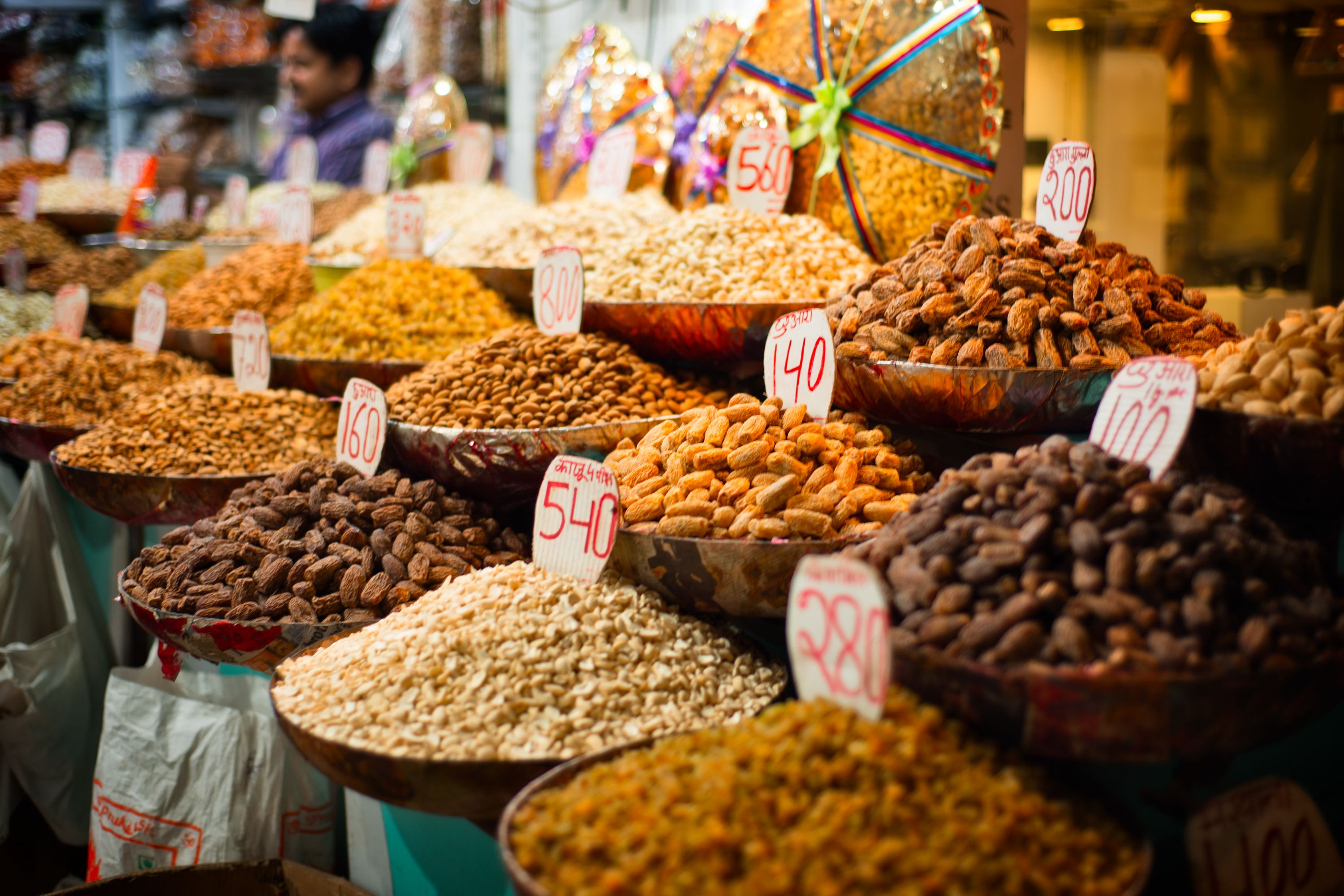 Bowls of spices and nuts on a market in India