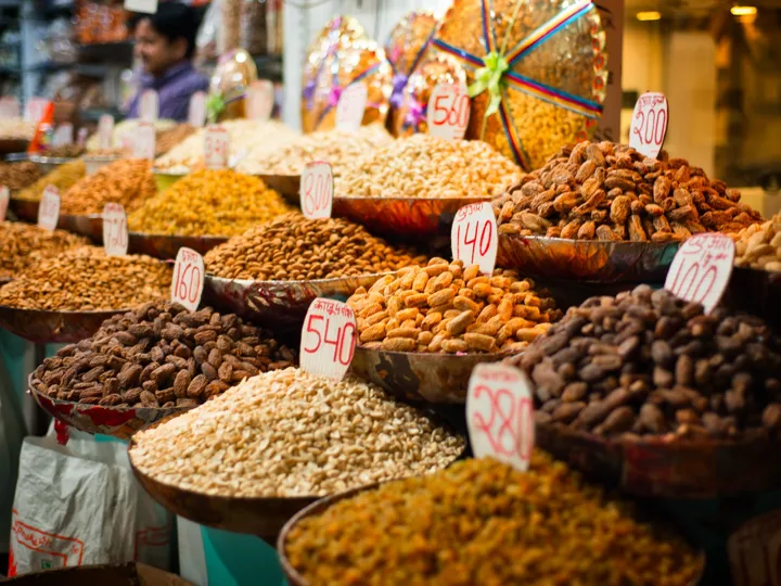 Bowls of spices and nuts on a market in India